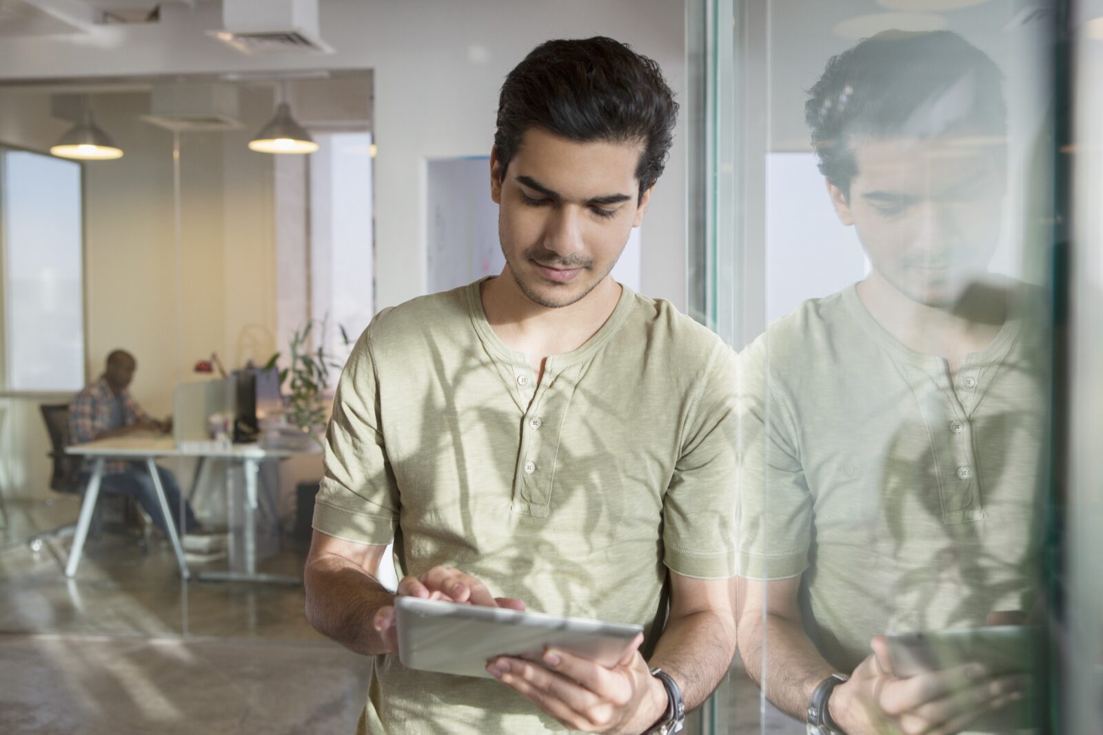 Young man using digital tablet in office