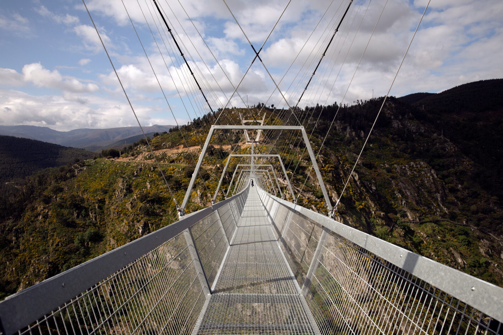 People walk on the world's longest pedestrian suspension bridge '516 Arouca', in Arouca