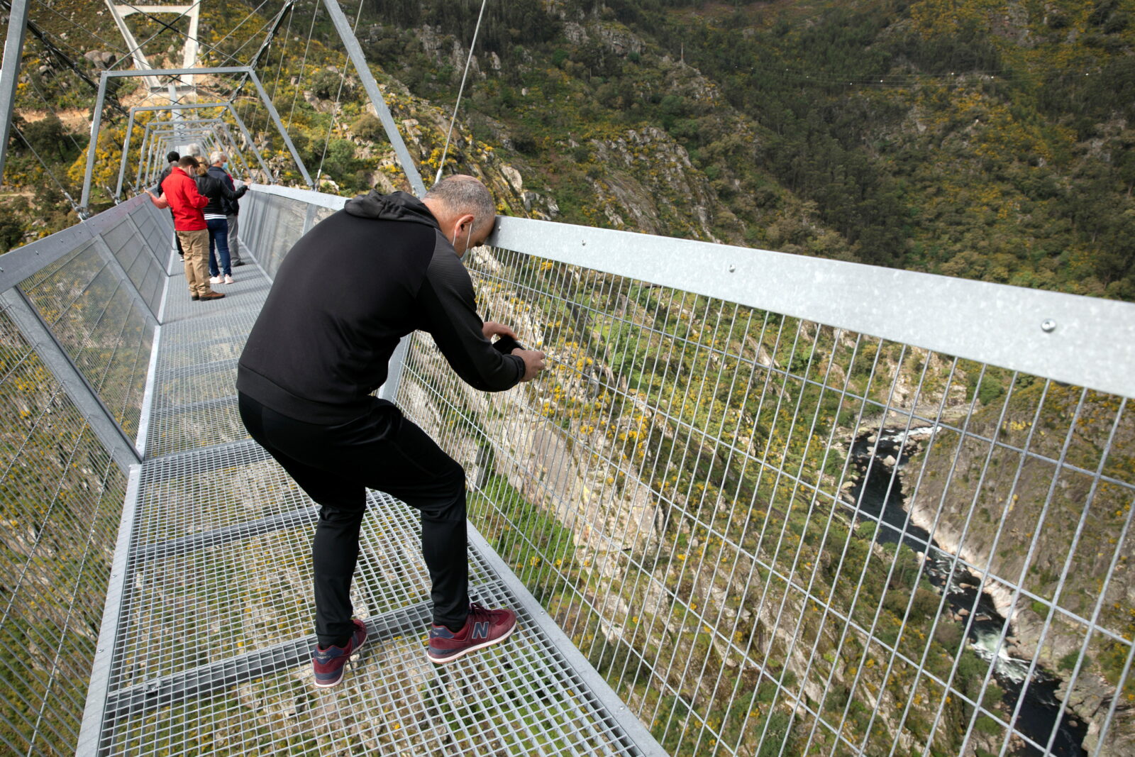 People walk on the world's longest pedestrian suspension bridge '516 Arouca', in Arouca