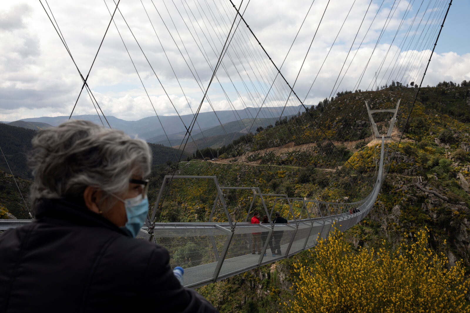 People walk on the world's longest pedestrian suspension bridge '516 Arouca', in Arouca