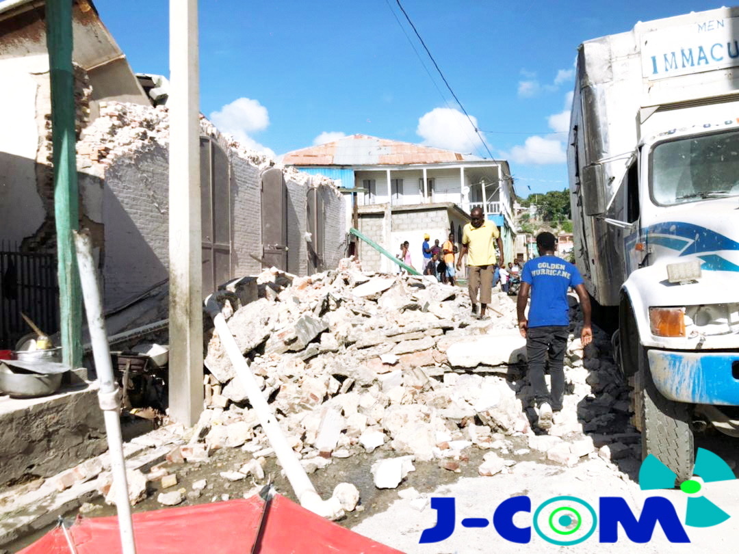 People walk through debris following an earthquake in Jeremie