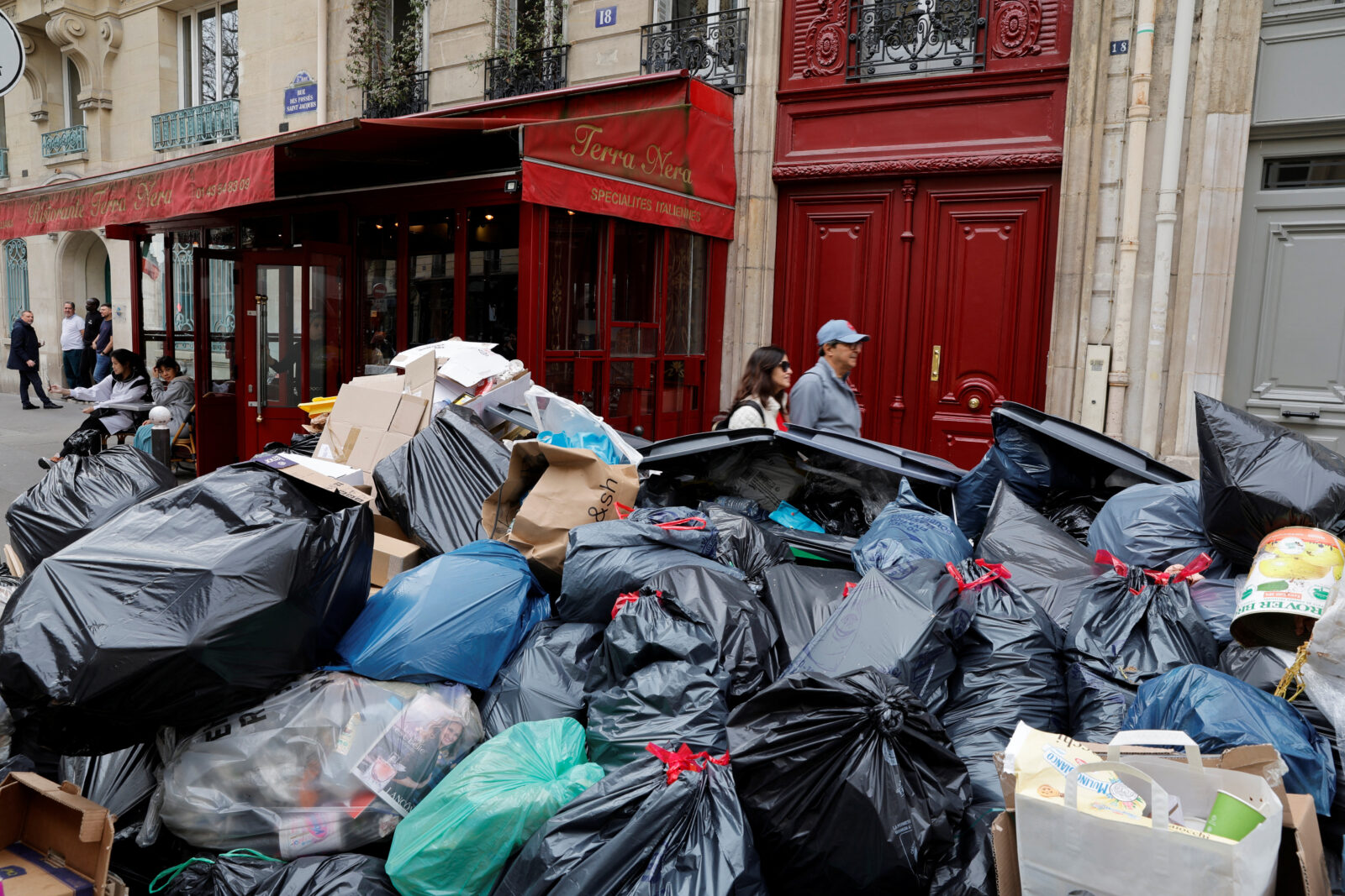 Garbage piles up as workers strike continues over pension reform in Paris